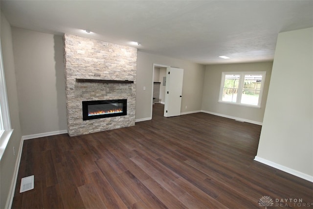 unfurnished living room with a fireplace and dark hardwood / wood-style flooring