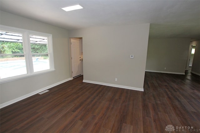 unfurnished room featuring dark hardwood / wood-style floors