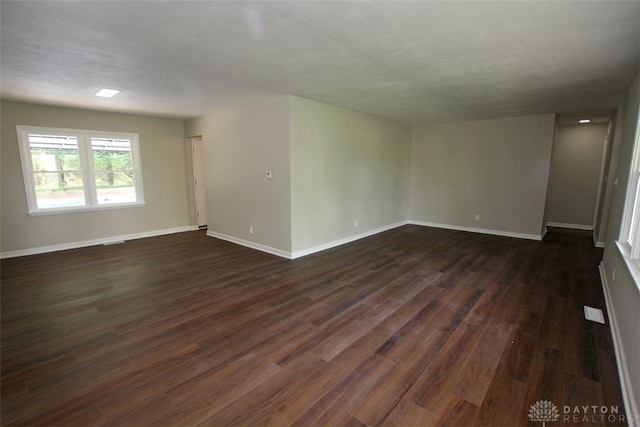 spare room with dark hardwood / wood-style floors