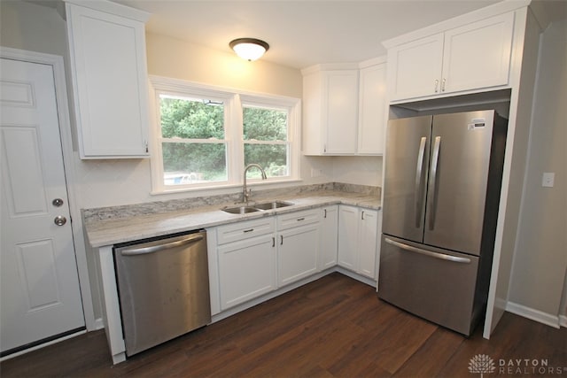 kitchen with white cabinets, appliances with stainless steel finishes, dark wood-type flooring, and sink