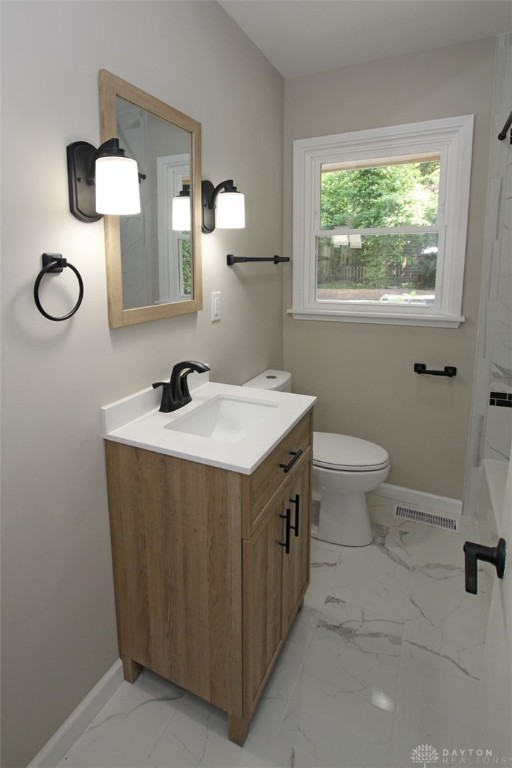 bathroom featuring vanity and toilet