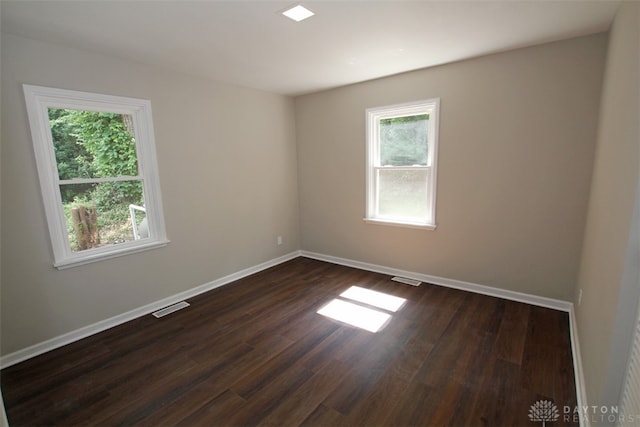 unfurnished room featuring dark hardwood / wood-style floors