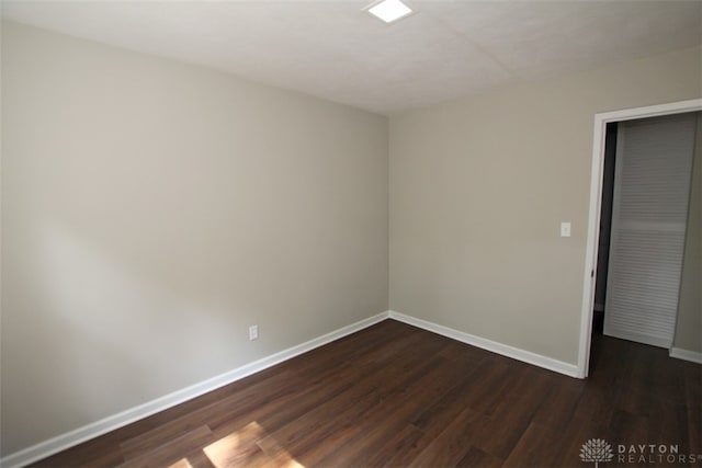 spare room featuring dark hardwood / wood-style flooring