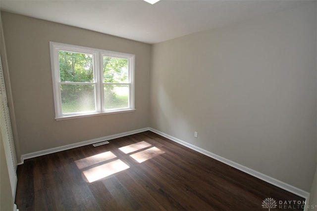 unfurnished room featuring dark hardwood / wood-style floors