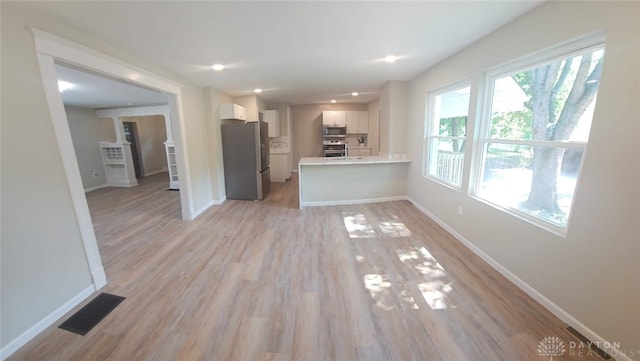 unfurnished living room with light hardwood / wood-style flooring