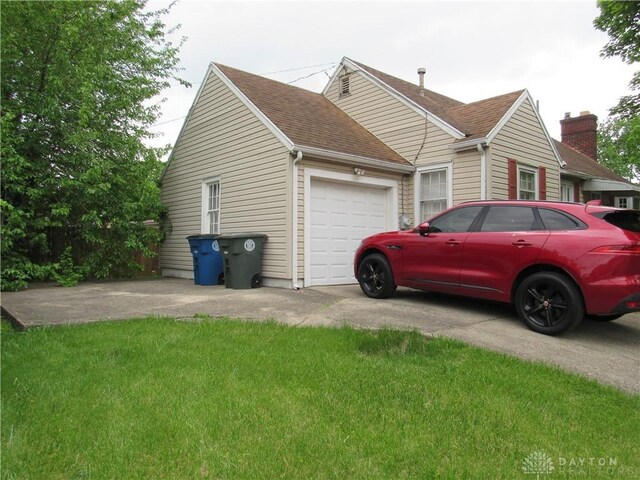 view of home's exterior featuring a garage and a yard