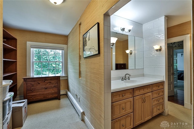 bathroom featuring vanity and baseboard heating