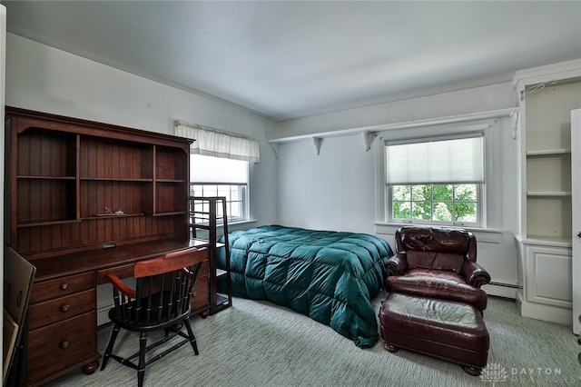 carpeted bedroom featuring baseboard heating