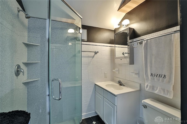 bathroom featuring toilet, vanity, and walk in shower