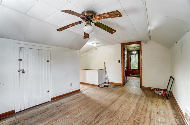 bonus room featuring visible vents, light wood-style flooring, vaulted ceiling, ceiling fan, and baseboards