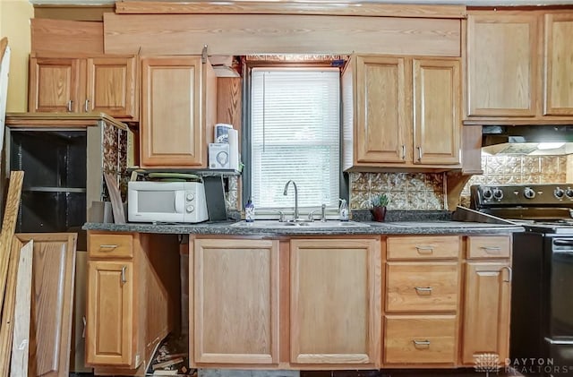 kitchen featuring dark countertops, black range with electric stovetop, a sink, and white microwave