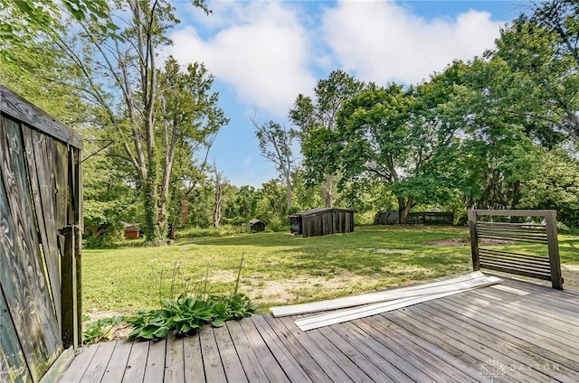 wooden terrace featuring a yard