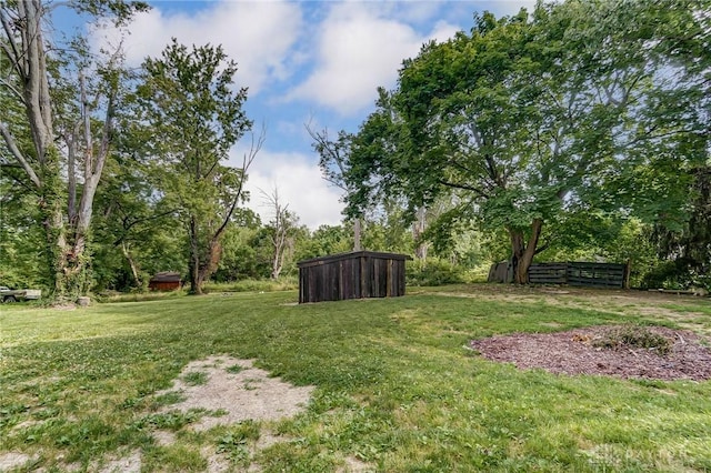 view of yard with an outdoor structure and fence