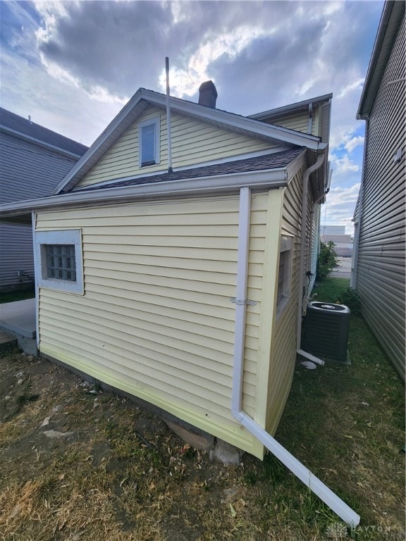 view of side of home with central air condition unit