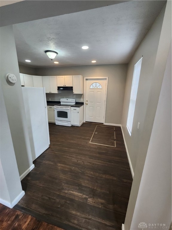 kitchen with white electric stove, dark hardwood / wood-style flooring, white cabinetry, and a textured ceiling