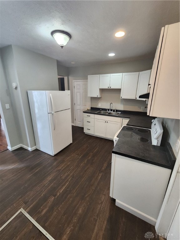 kitchen featuring white cabinetry, dark wood-type flooring, and white appliances