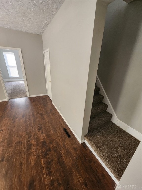 entryway featuring a textured ceiling and hardwood / wood-style floors