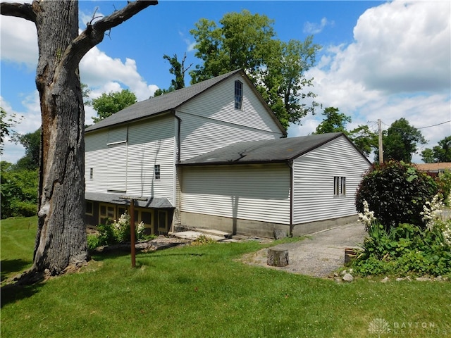 view of side of property with a lawn