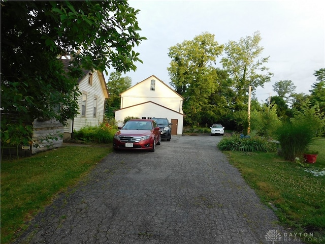 exterior space with a garage and a front lawn