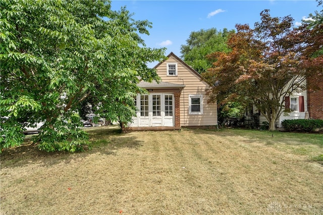 view of front of house featuring french doors and a front lawn