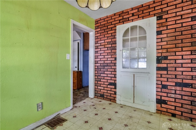 interior space featuring brick wall