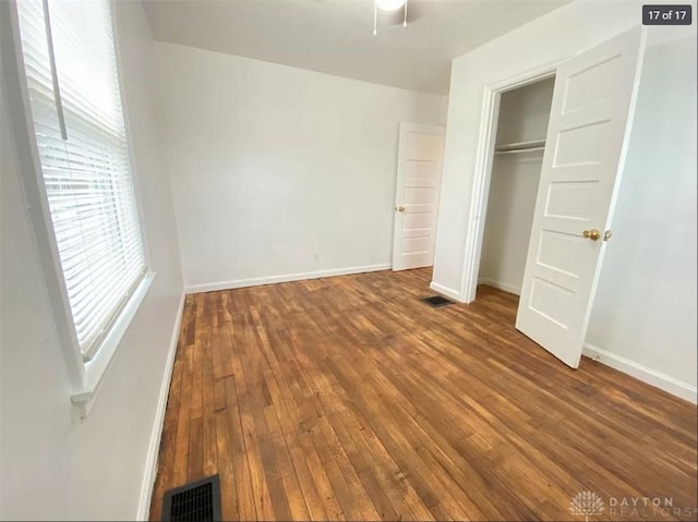 unfurnished bedroom with hardwood / wood-style floors and a closet