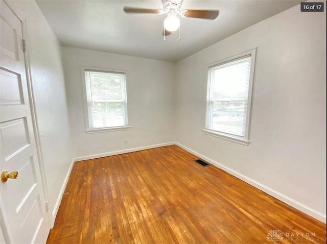 spare room featuring hardwood / wood-style floors and ceiling fan