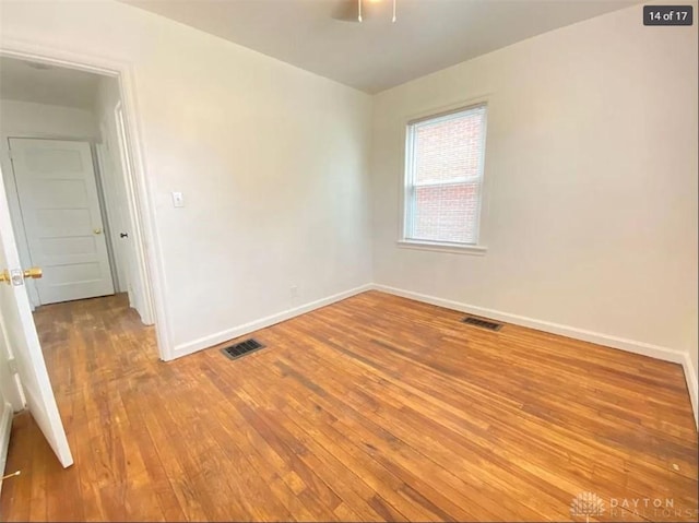 spare room featuring wood-type flooring