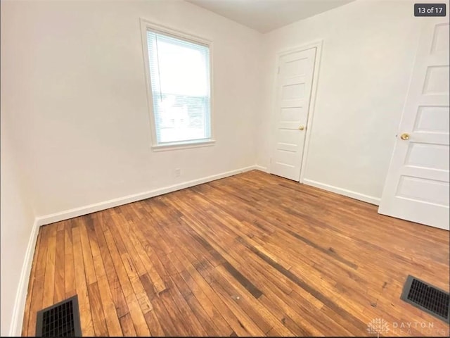 unfurnished room with hardwood / wood-style flooring