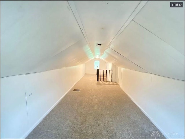 bonus room with carpet and vaulted ceiling