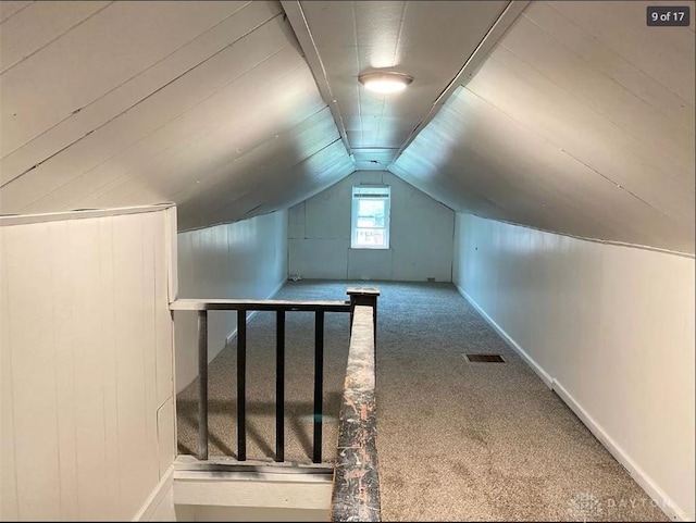 bonus room with carpet flooring and lofted ceiling