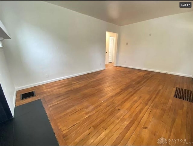 empty room with hardwood / wood-style flooring