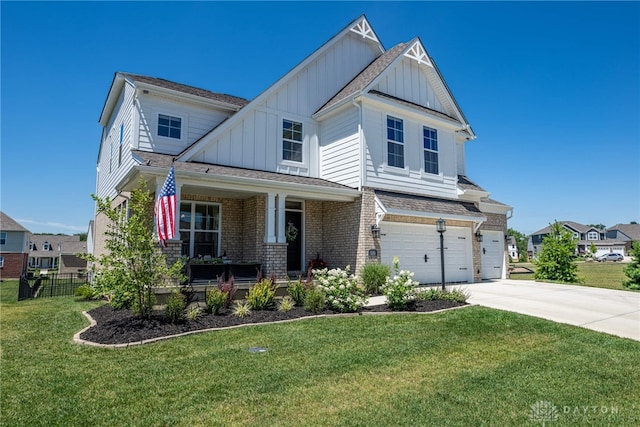 craftsman-style home featuring covered porch, a garage, and a front yard