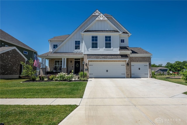 craftsman-style house with covered porch, a garage, and a front yard