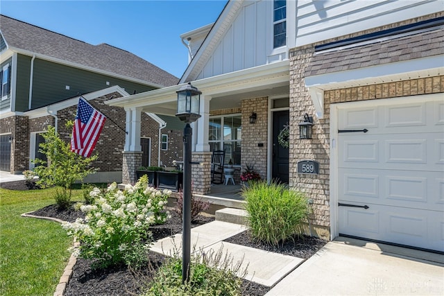 property entrance featuring covered porch and a garage