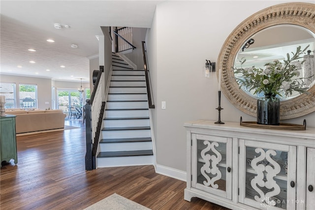 staircase featuring hardwood / wood-style floors and ornamental molding