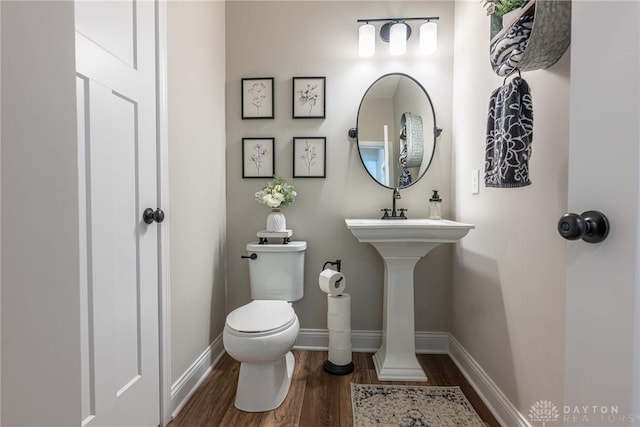 bathroom featuring toilet and hardwood / wood-style flooring