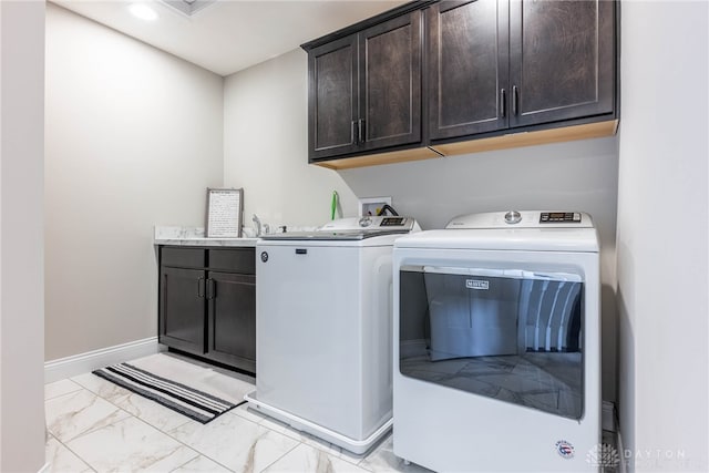 laundry area with washing machine and dryer and cabinets