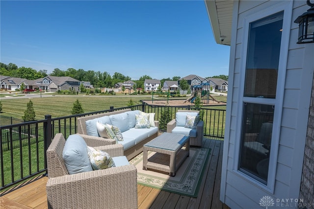 wooden terrace with an outdoor hangout area and a playground