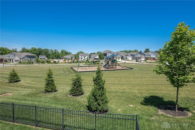 exterior space with a playground and a lawn