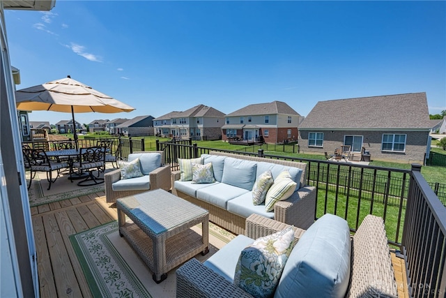 wooden deck featuring outdoor lounge area and a yard