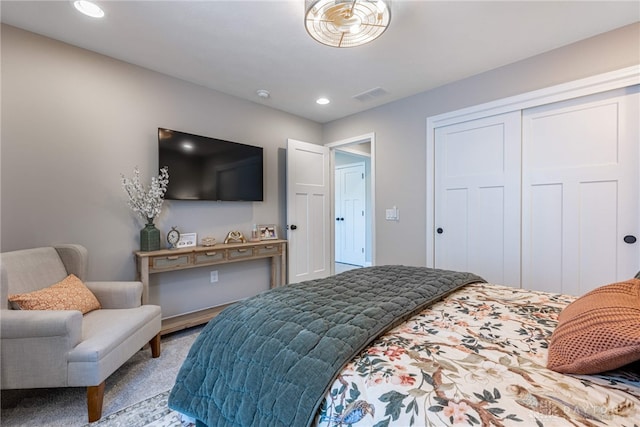 bedroom featuring light colored carpet and a closet