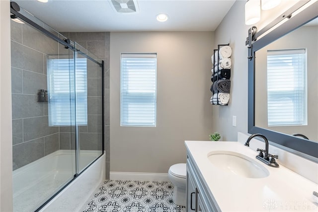 full bathroom featuring tile patterned floors, plenty of natural light, toilet, and vanity