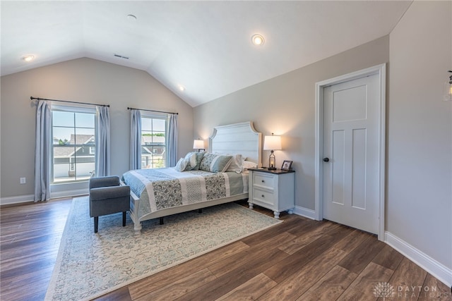 bedroom with dark hardwood / wood-style flooring and vaulted ceiling