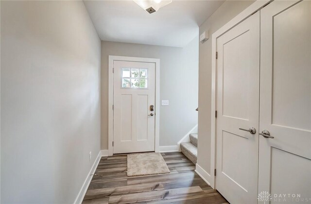 2905 Acorn Dr, Kettering, OH 45419 - entryway featuring wood finished floors, baseboards, and stairs