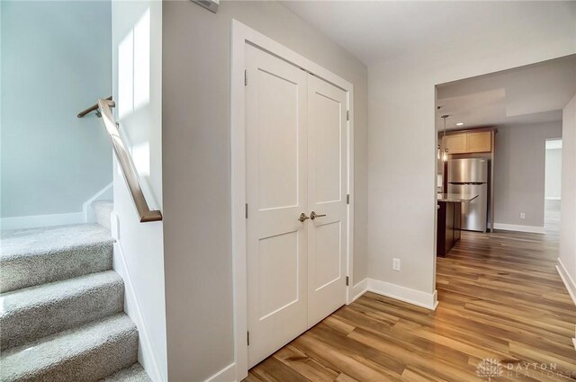 staircase with hardwood / wood-style flooring