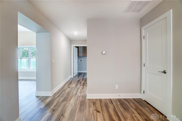 corridor with light hardwood / wood-style flooring