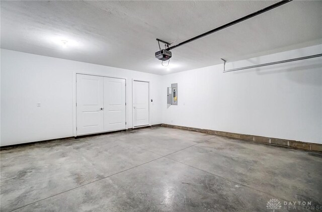 garage featuring a garage door opener and electric panel