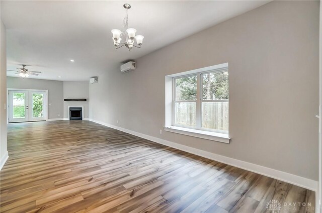 unfurnished living room featuring plenty of natural light and wood-type flooring