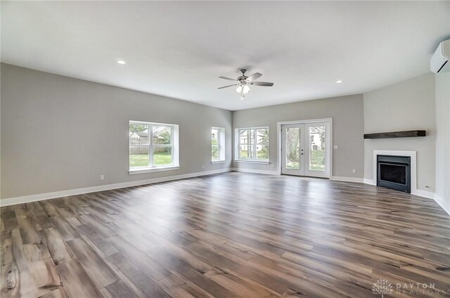 unfurnished living room with dark hardwood / wood-style floors and ceiling fan